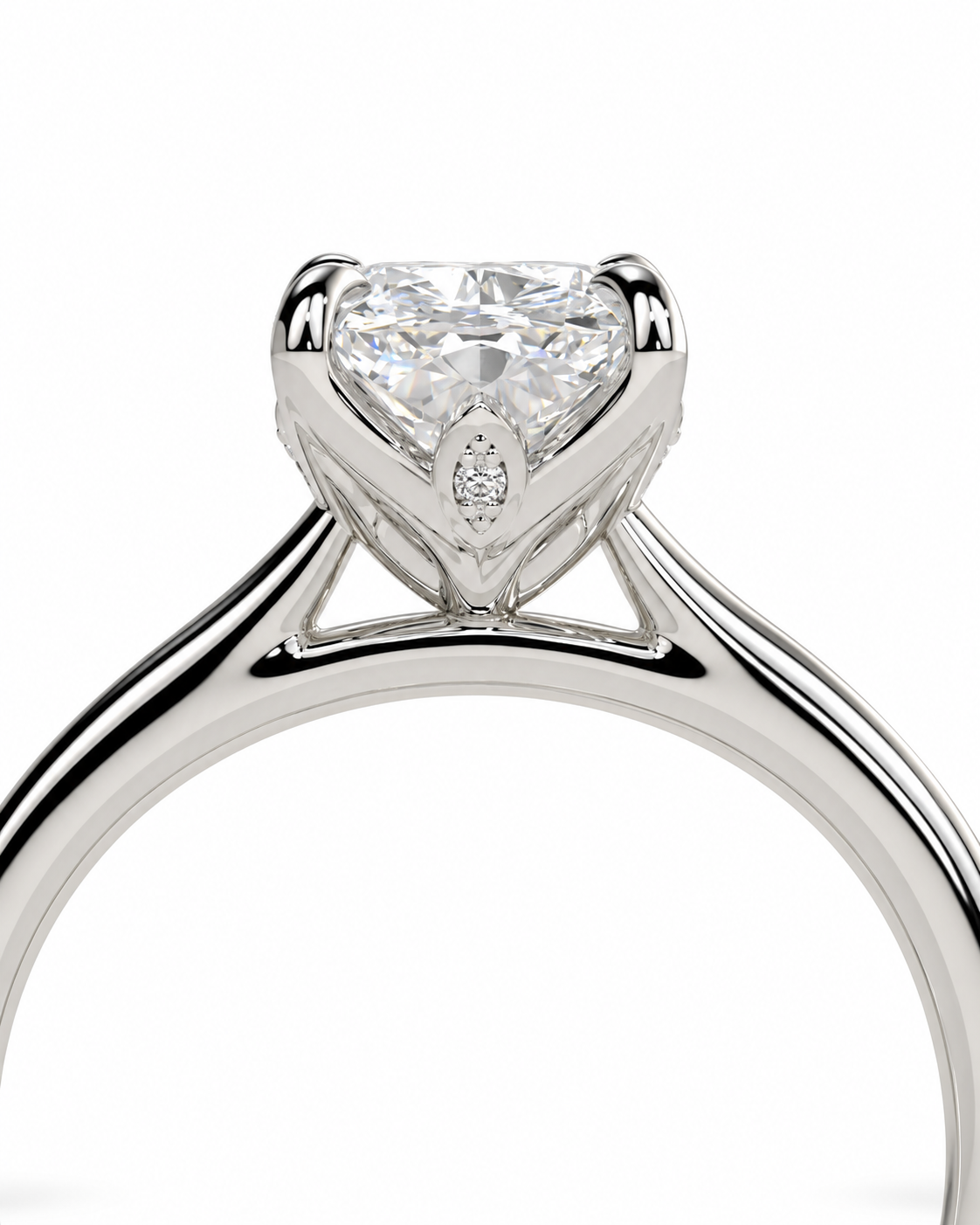 color_925_SIL,color_935_ARG,color_10K_WG, color_14K_WG &&A close-up studio shot of a silver-toned diamond ring featuring a heart-shaped clear gemstone in a four-prong setting with a small accent stone below it, shown against a plain white background.