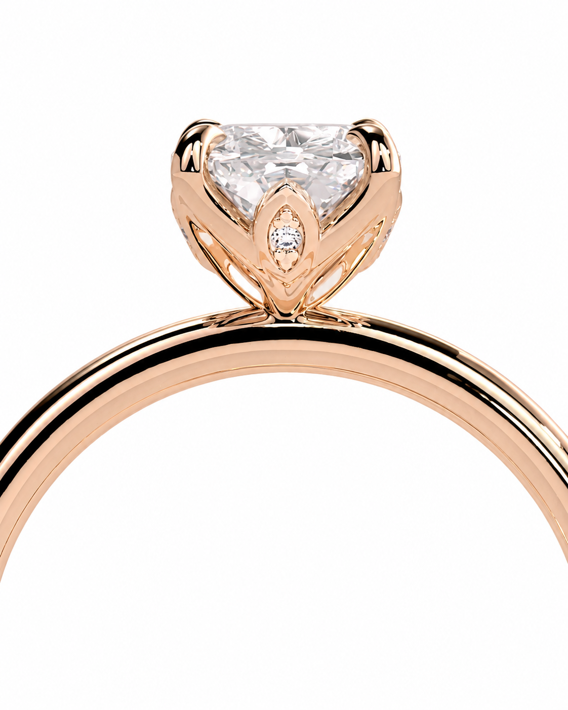 color_10K_RG, color_14K_RG &&Rose gold engagement ring with a large clear round-cut center stone and a small marquise-cut accent stone, shown on a white background.