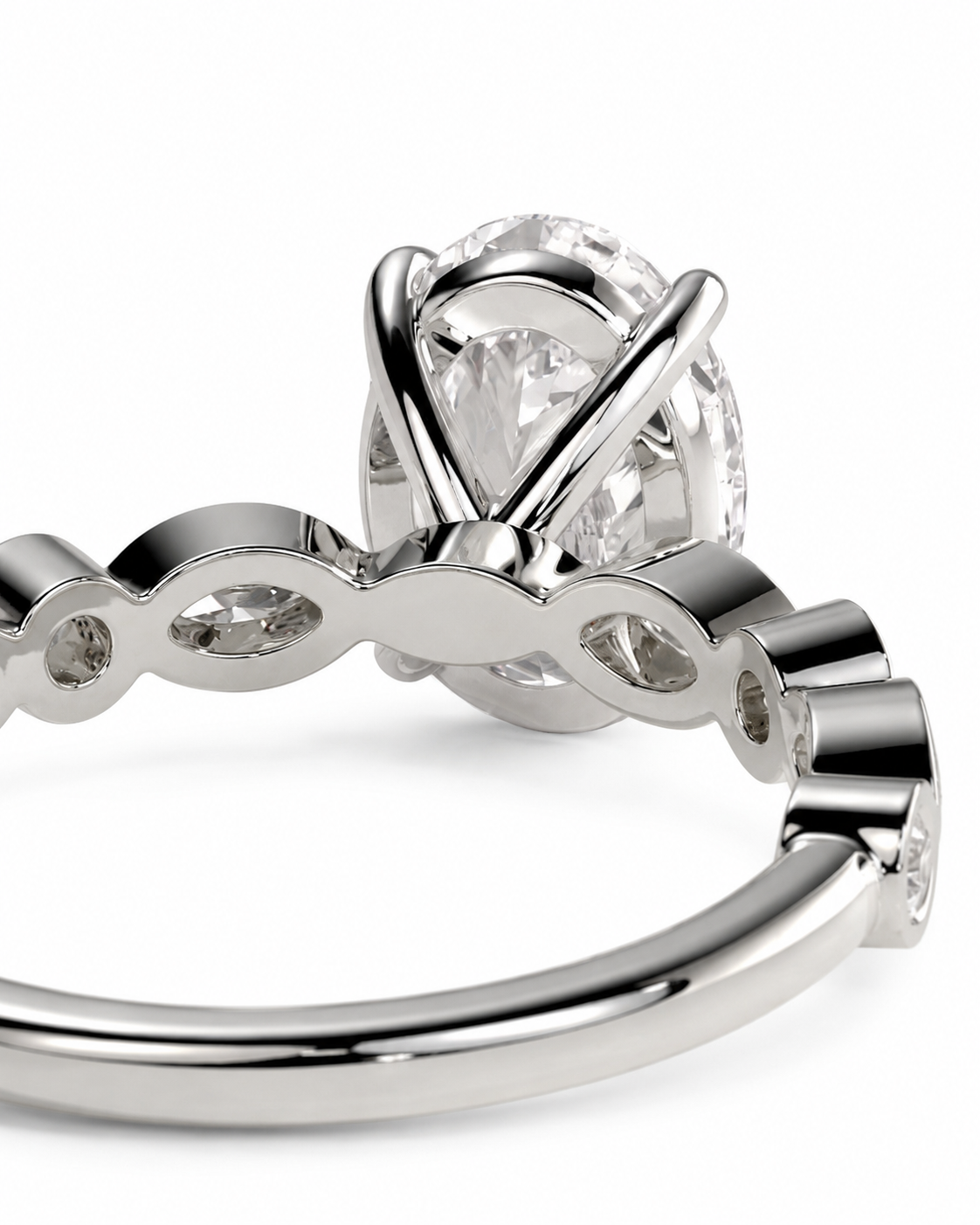 color_925_SIL,color_935_ARG,color_10K_WG, color_14K_WG &&Close-up of a silver-toned engagement ring featuring a round brilliant-cut center stone in a prong setting, with a curved band accented by small pavé-set round stones, on a white background.