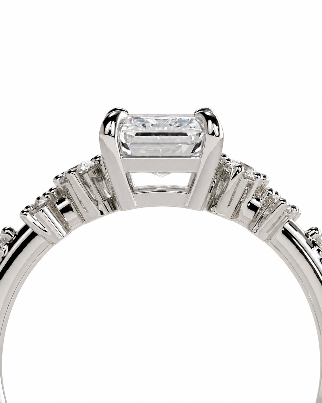 color_925_SIL,color_935_ARG,color_10K_WG, color_14K_WG &&A close-up studio shot of a silver-toned diamond ring featuring a large rectangular emerald-cut center stone and smaller diamonds along the shoulders, set against a plain white background.