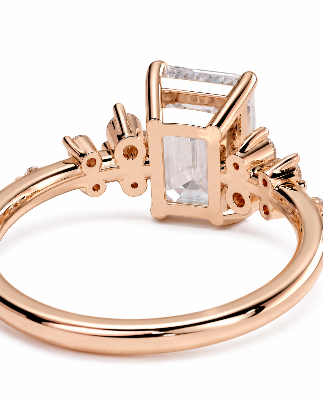 color_10K_RG, color_14K_RG &&Rose gold ring with a large rectangular clear gemstone and smaller accent stones on the band, shown on a white background.