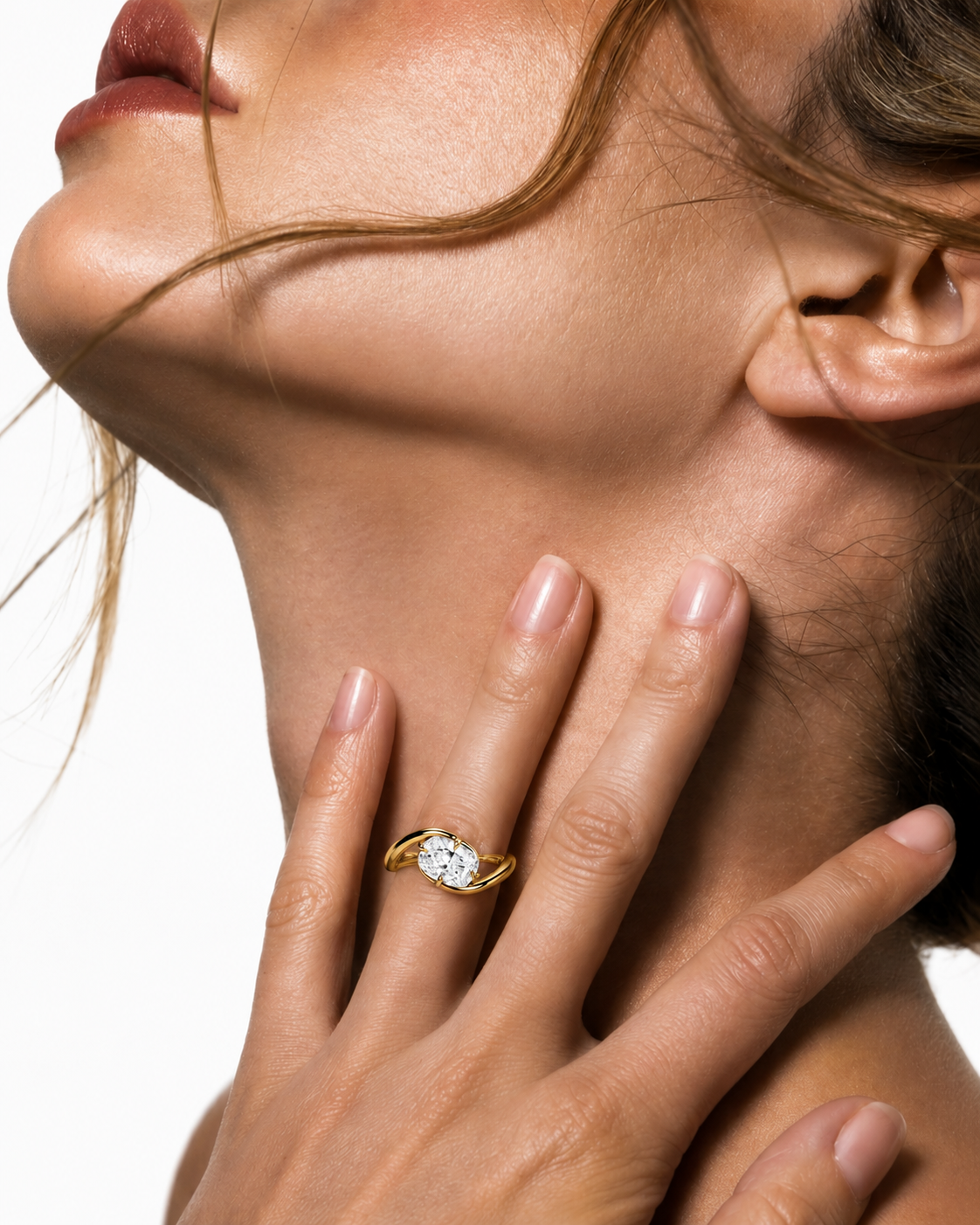 color_10K_YG, color_14K_YG && close-up lifestyle shot of a woman's neck and hand wearing a yellow gold ring with a round-cut clear gemstone, set against a clean white background.