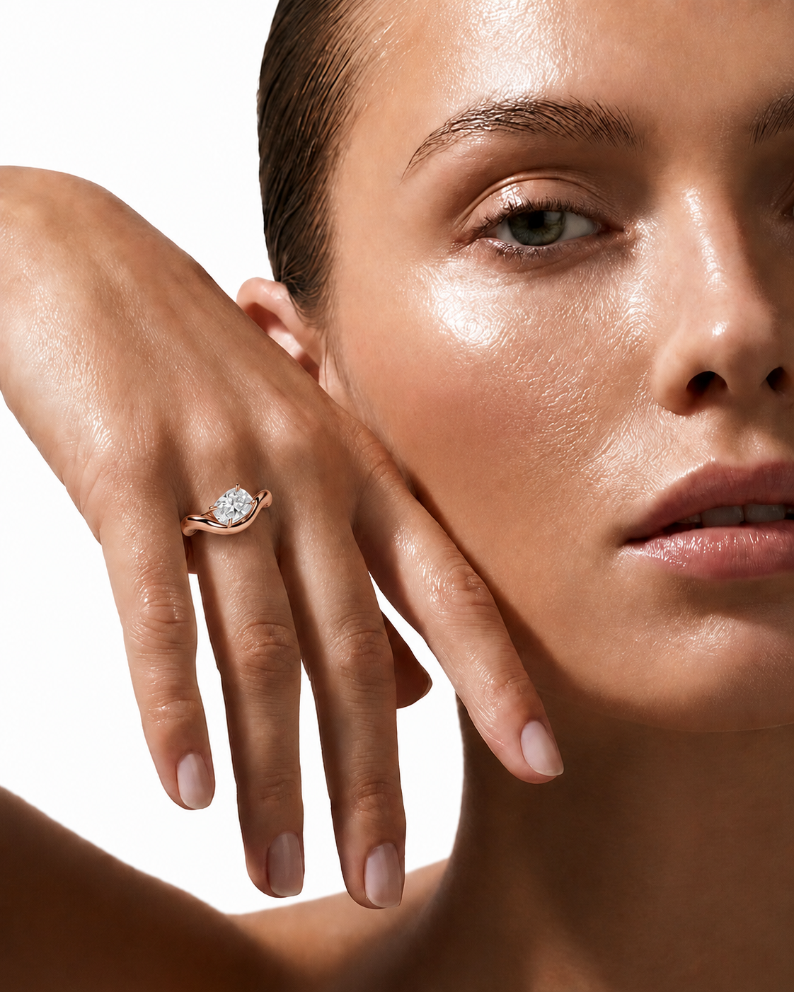 color_10K_RG, color_14K_RG &&A close-up lifestyle shot of a model wearing a rose gold ring with a round-cut clear gemstone on her finger, set against a clean white background.