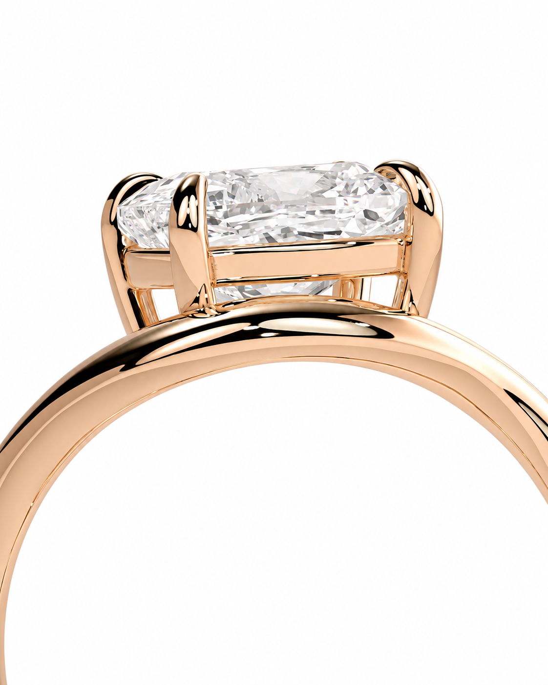 color_10K_RG, color_14K_RG &&Close-up of a rose gold ring with a rectangular clear gemstone in a prong setting, shown against a plain white background.