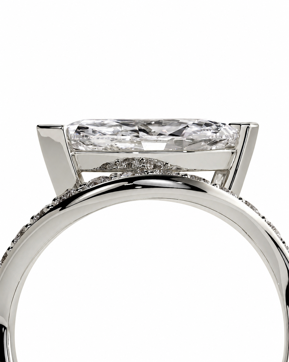 color_925_SIL,color_935_ARG,color_10K_WG, color_14K_WG &&A close-up studio shot of a silver-toned ring featuring a large rectangular clear gemstone in a prong setting, with smaller accent stones along the band, on a plain white background.