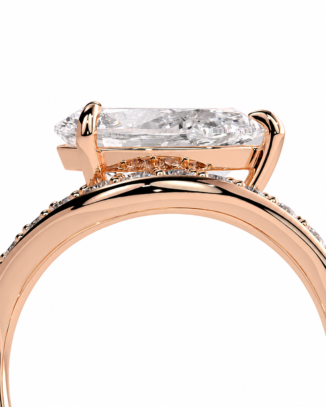 color_10K_RG, color_14K_RG &&Close-up of a rose gold ring with a large rectangular clear gemstone and small accent stones along the band, shown on a white background.