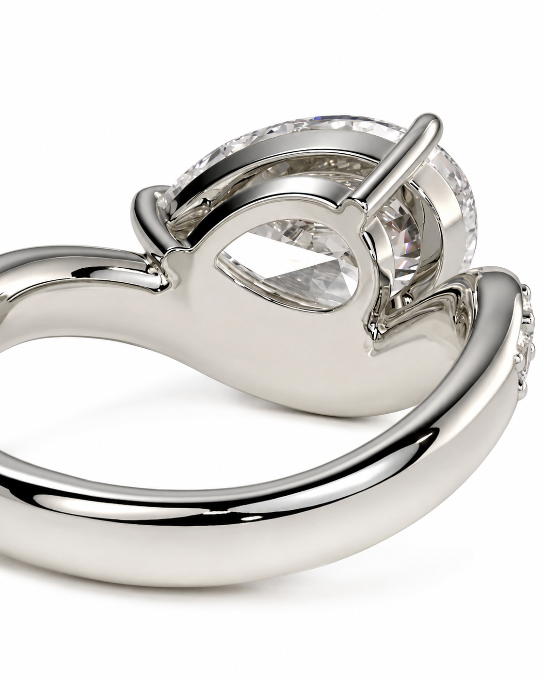 color_925_SIL,color_935_ARG,color_10K_WG, color_14K_WG &&A close-up shot of a polished silver-tone ring with a large clear teardrop-cut gemstone in a prong setting, shown against a plain white background.