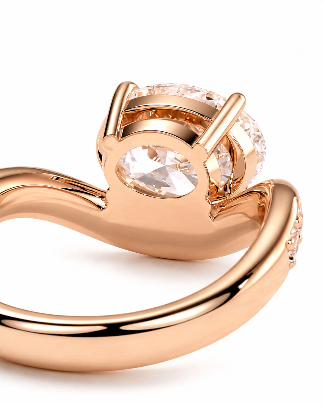 color_10K_RG, color_14K_RG &&A close-up of a rose gold ring featuring a marquise-cut clear center stone and a halo of smaller clear stones, set against a plain white background.