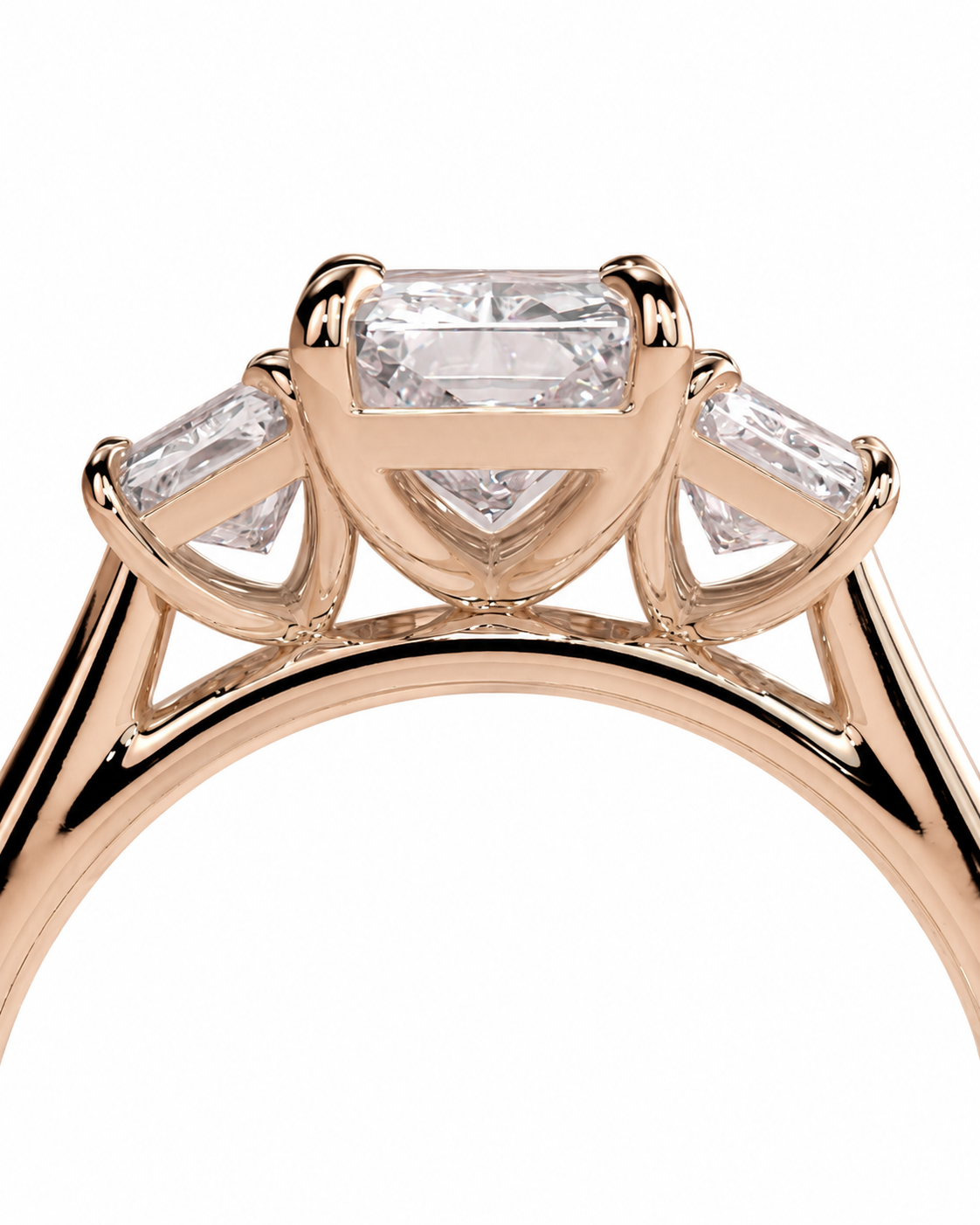 color_10K_RG, color_14K_RG &&Rose gold ring with a large rectangular center stone and three smaller baguette side stones, shown in a close-up studio shot on a white background.