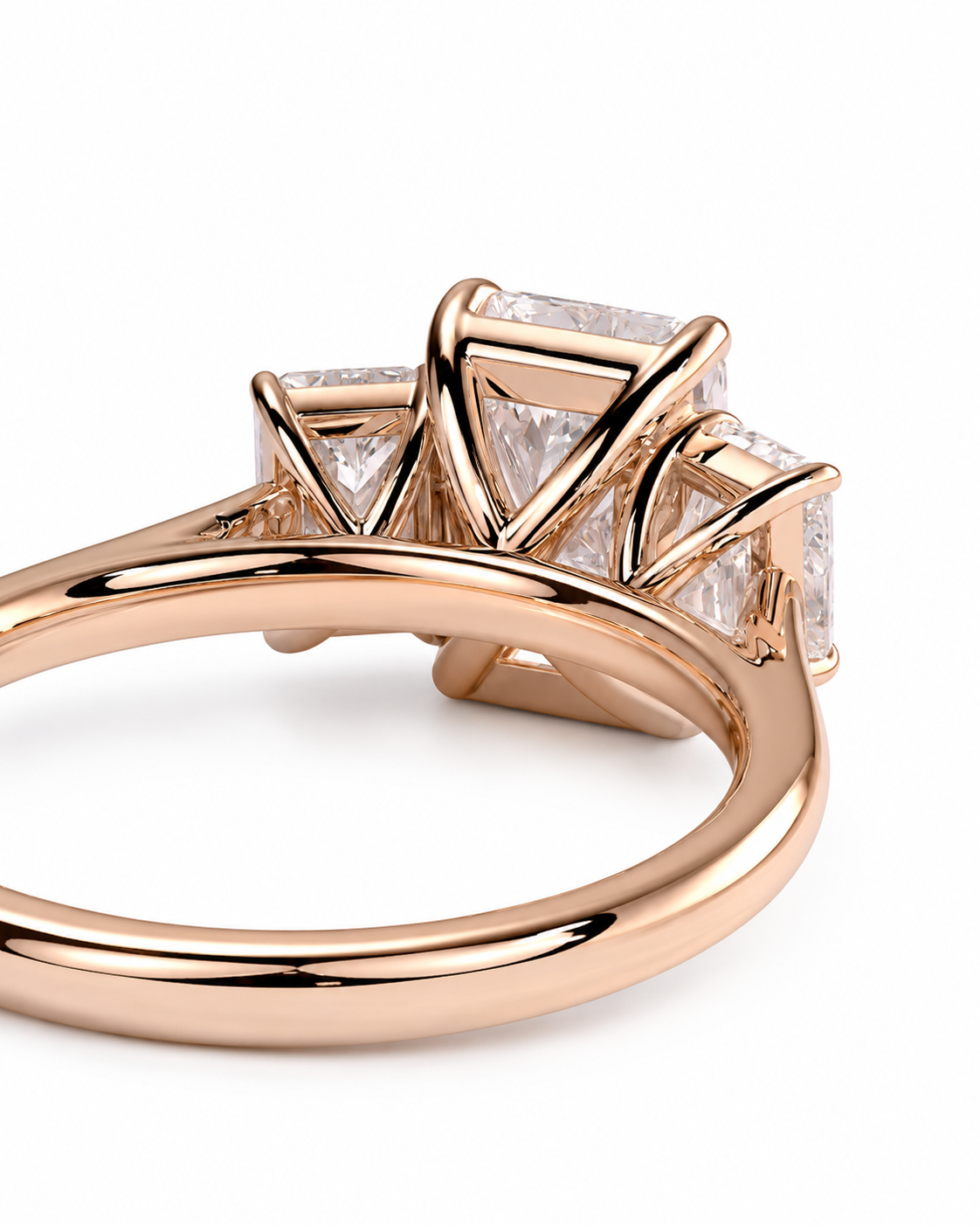 color_10K_RG, color_14K_RG &&Rose gold ring with three princess-cut clear gemstones in a three-stone setting, shown on a clean white background.