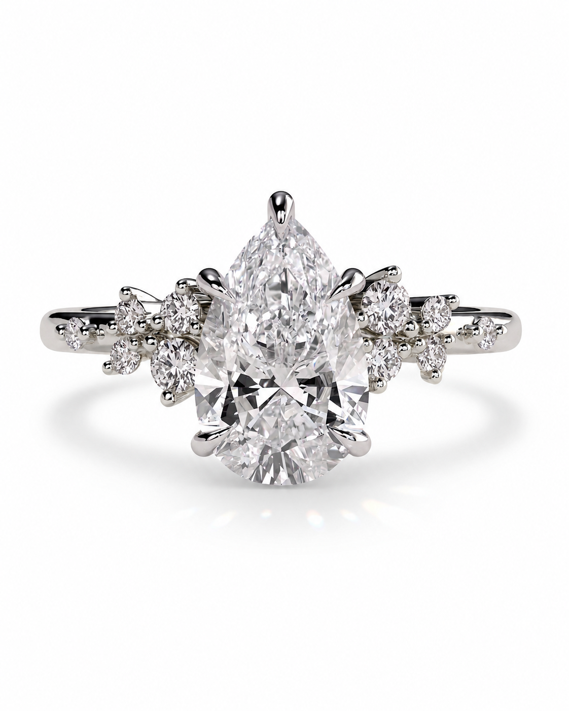 color_925_SIL,color_935_ARG,color_10K_WG, color_14K_WG &&A pear-cut diamond engagement ring with a brilliant center stone and small diamond accents on the shoulders, set in a silver-colored metal band against a white background.