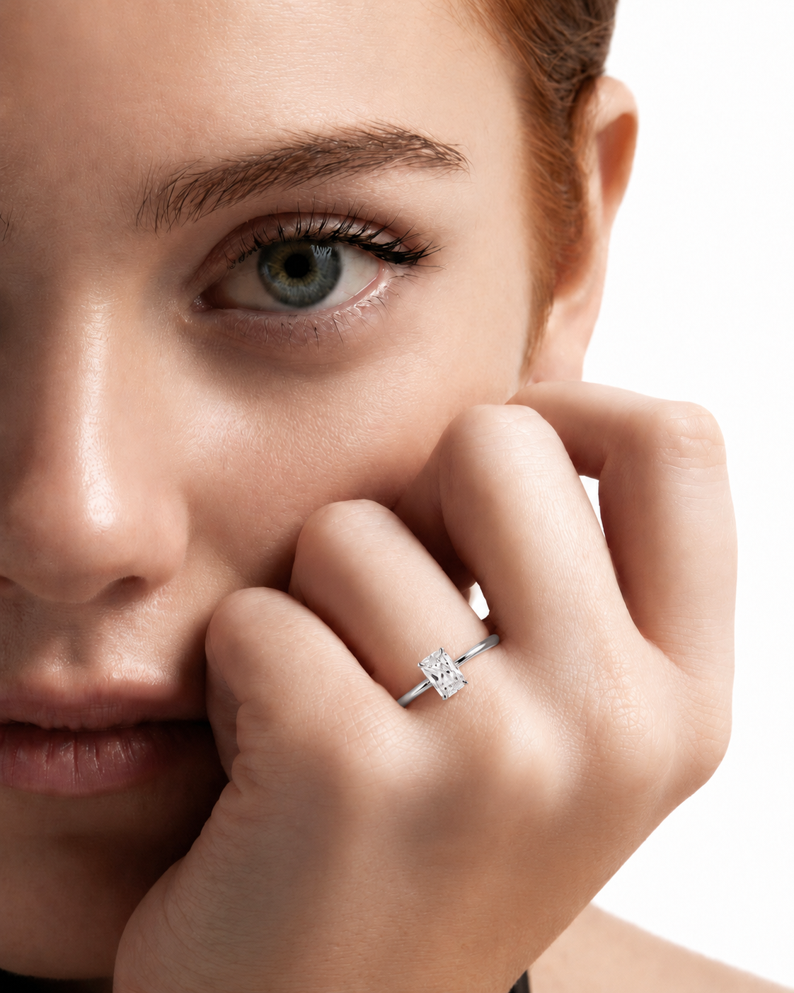 color_925_SIL,color_935_ARG,color_10K_WG, color_14K_WG &&A close-up lifestyle shot of a model wearing a silver-toned ring with a square-cut clear gemstone on her finger, set against a clean white background.