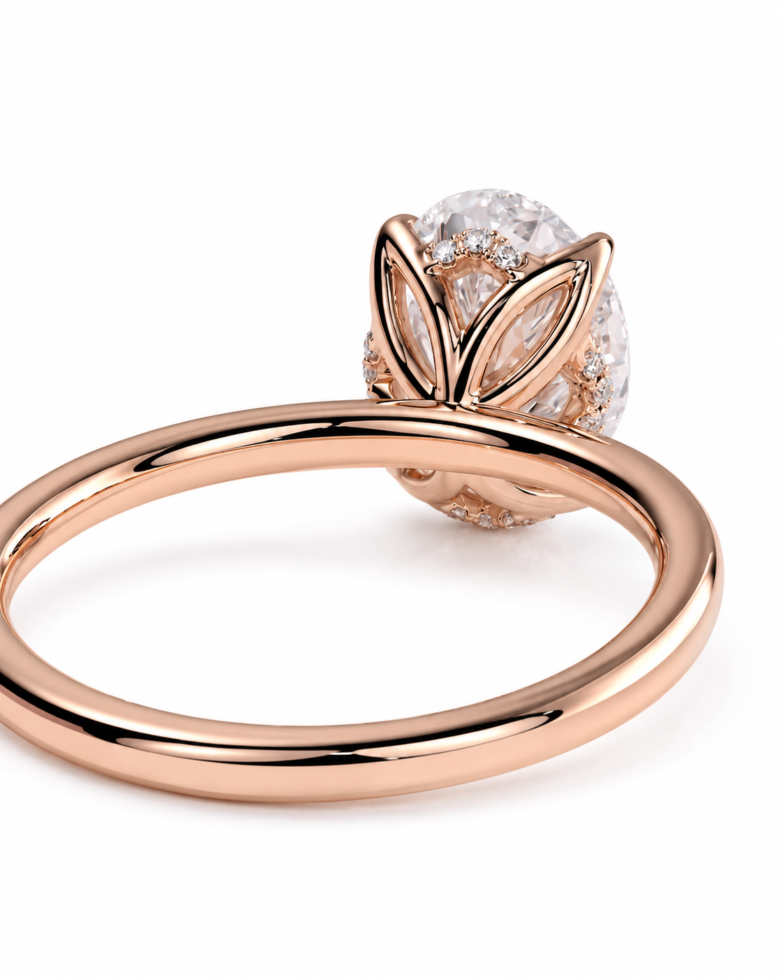 color_10K_RG, color_14K_RG &&A rose gold ring with a large oval diamond and smaller accent diamonds in a leaf-like setting, shown on a clean white background.