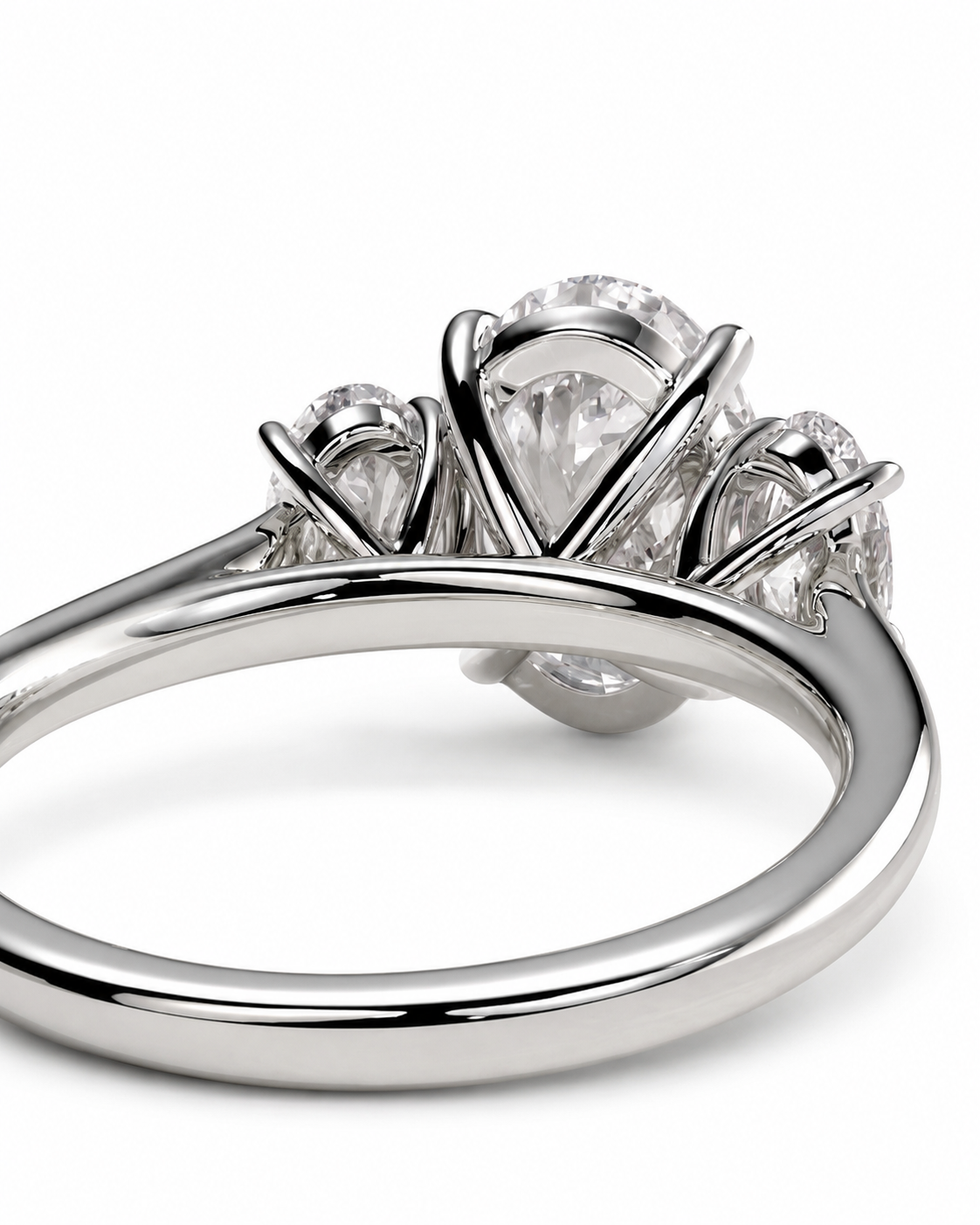 color_925_SIL,color_935_ARG,color_10K_WG, color_14K_WG &&A close-up studio shot of a silver-toned ring featuring a large oval center stone with smaller round stones on either side, set against a clean white background.