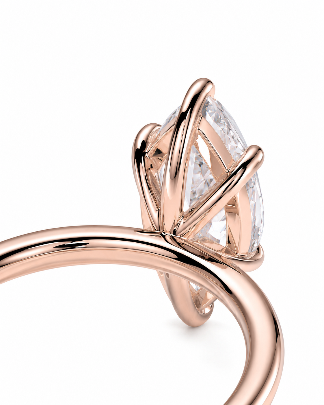 color_10K_RG, color_14K_RG &&Rose gold ring with a marquise-cut clear gemstone in a curved prong setting, shown on a white background.
