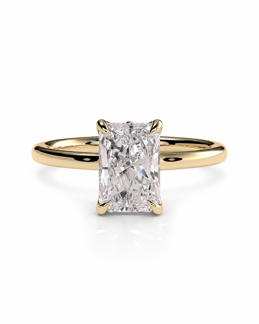 color_10K_YG, color_14K_YG &&An engagement ring featuring a rectangular radiant-cut diamond set in a yellow gold four-prong band, shown on a clean white background.