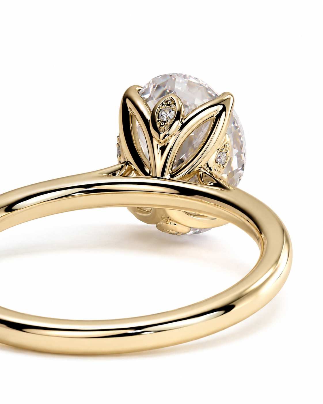 color_10K_YG, color_14K_YG &&A close-up shot of a yellow gold ring featuring a large oval clear gemstone in a leaf-like setting with small accent diamonds, on a plain white background.