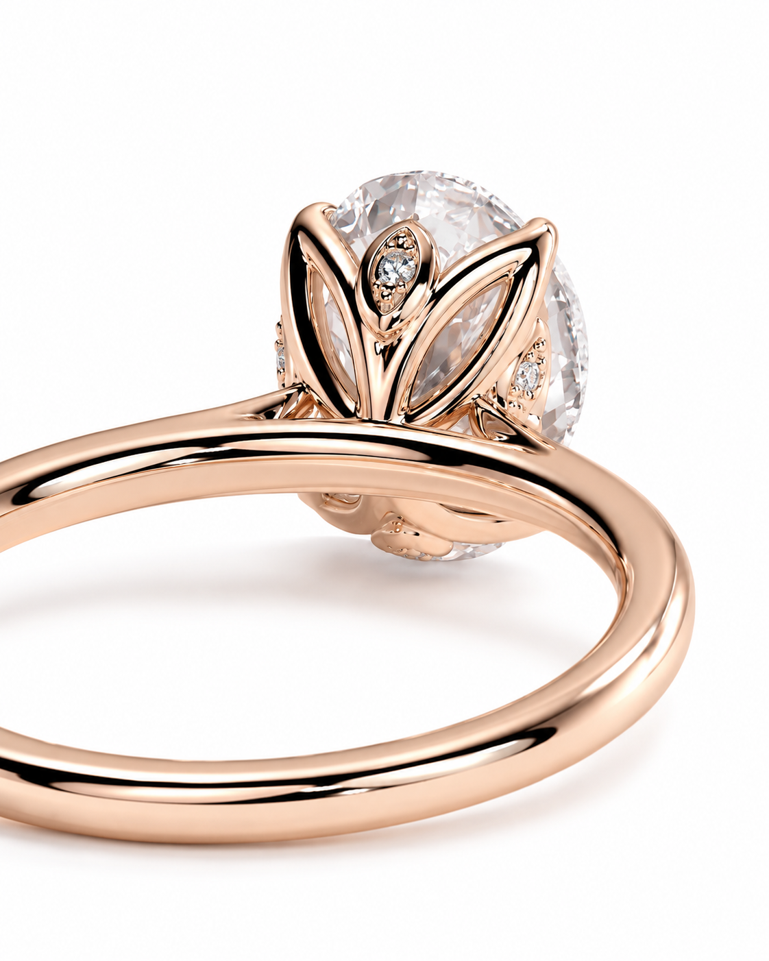 color_10K_RG, color_14K_RG &&Rose gold ring with a large oval clear gemstone in a leaf-like setting, shown on a clean white background.