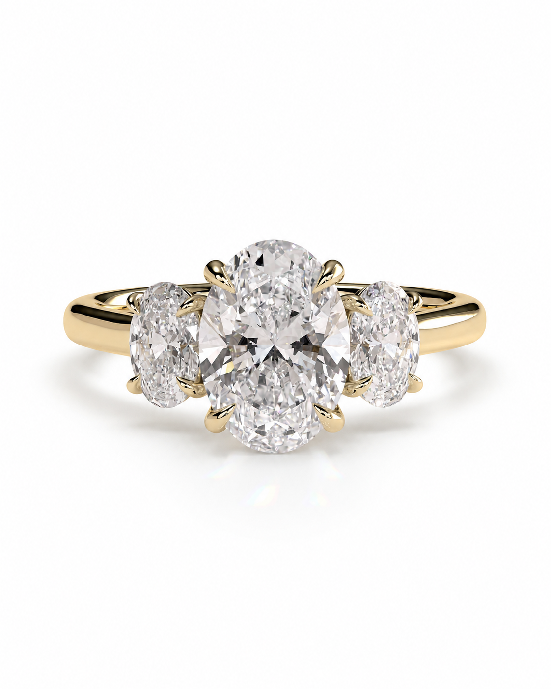 color_10K_YG, color_14K_YG &&A yellow gold three-stone diamond engagement ring with a large oval center diamond and two smaller round side diamonds, shown on a clean white background.
