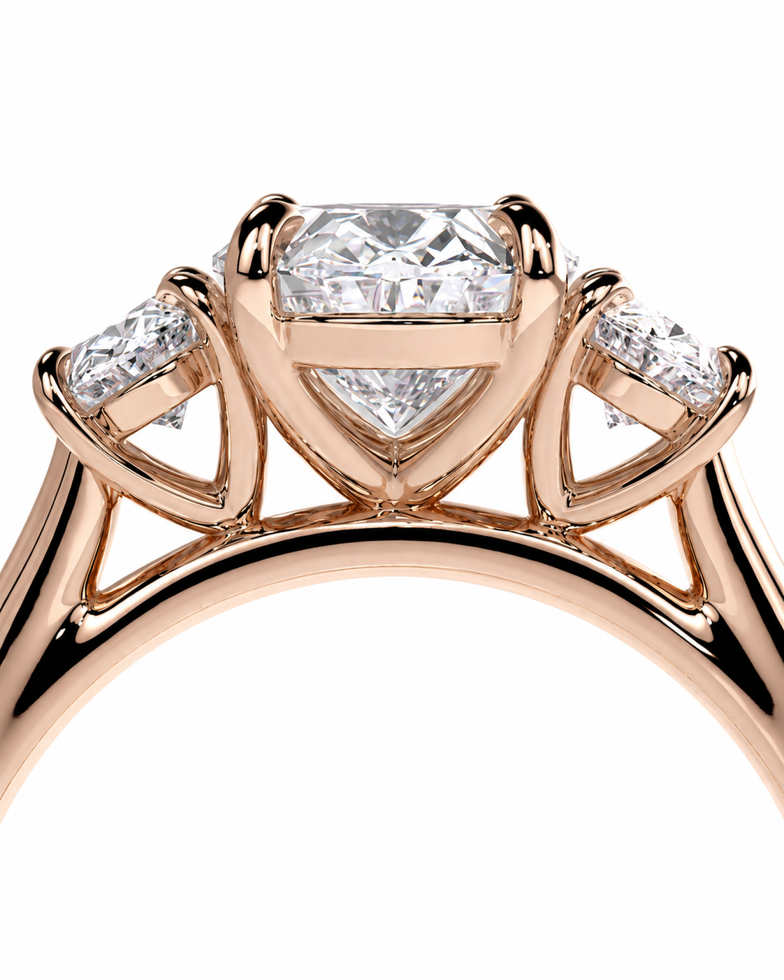 color_10K_RG, color_14K_RG &&Rose gold ring with a large round brilliant-cut center stone and two smaller round stones on either side, shown in a close-up studio shot on a white background.