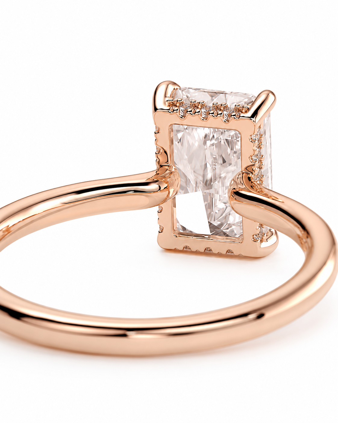 color_10K_RG, color_14K_RG &&Rose gold ring with a rectangular clear gemstone and small accent stones on the band, shown on a white background.