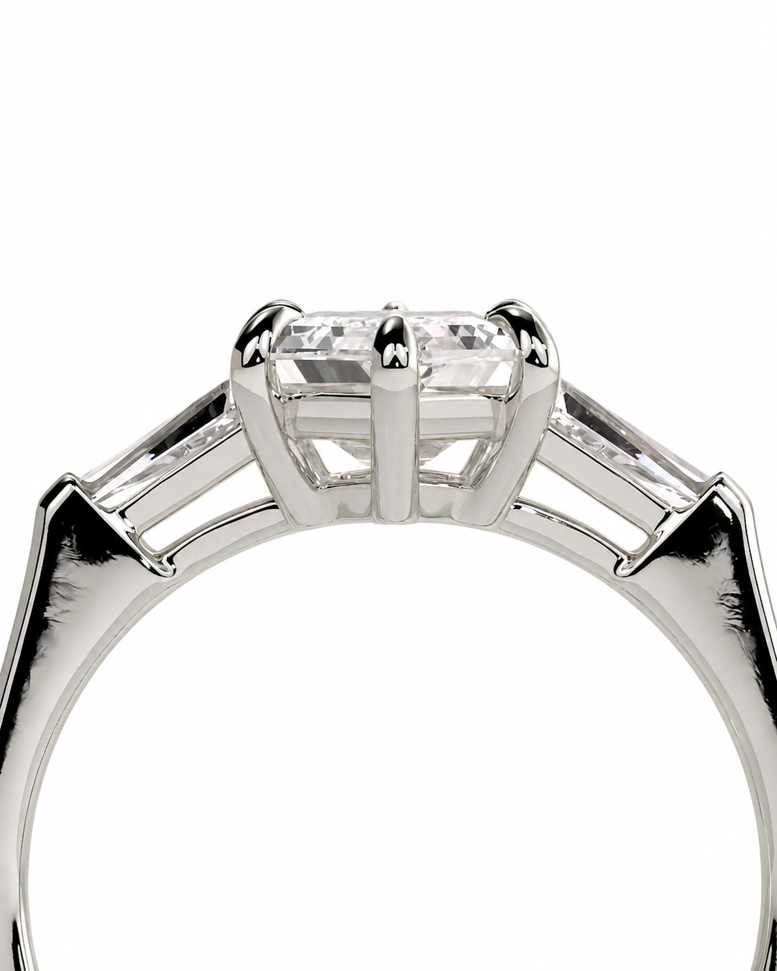 color_925_SIL,color_935_ARG,color_10K_WG, color_14K_WG &&A close-up studio shot of a silver-toned ring featuring a rectangular clear center stone in a prong setting, with smaller side stones on a white background.