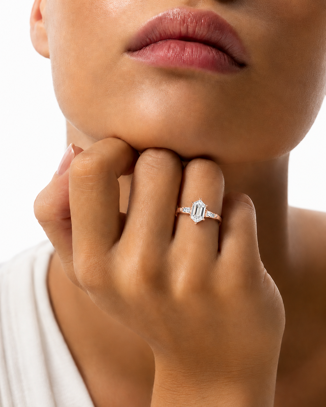 color_10K_RG, color_14K_RG &&A close-up lifestyle shot of a model wearing a silver ring with a central baguette-cut diamond. The model's hand, lips, and chin are visible against a clean white background.