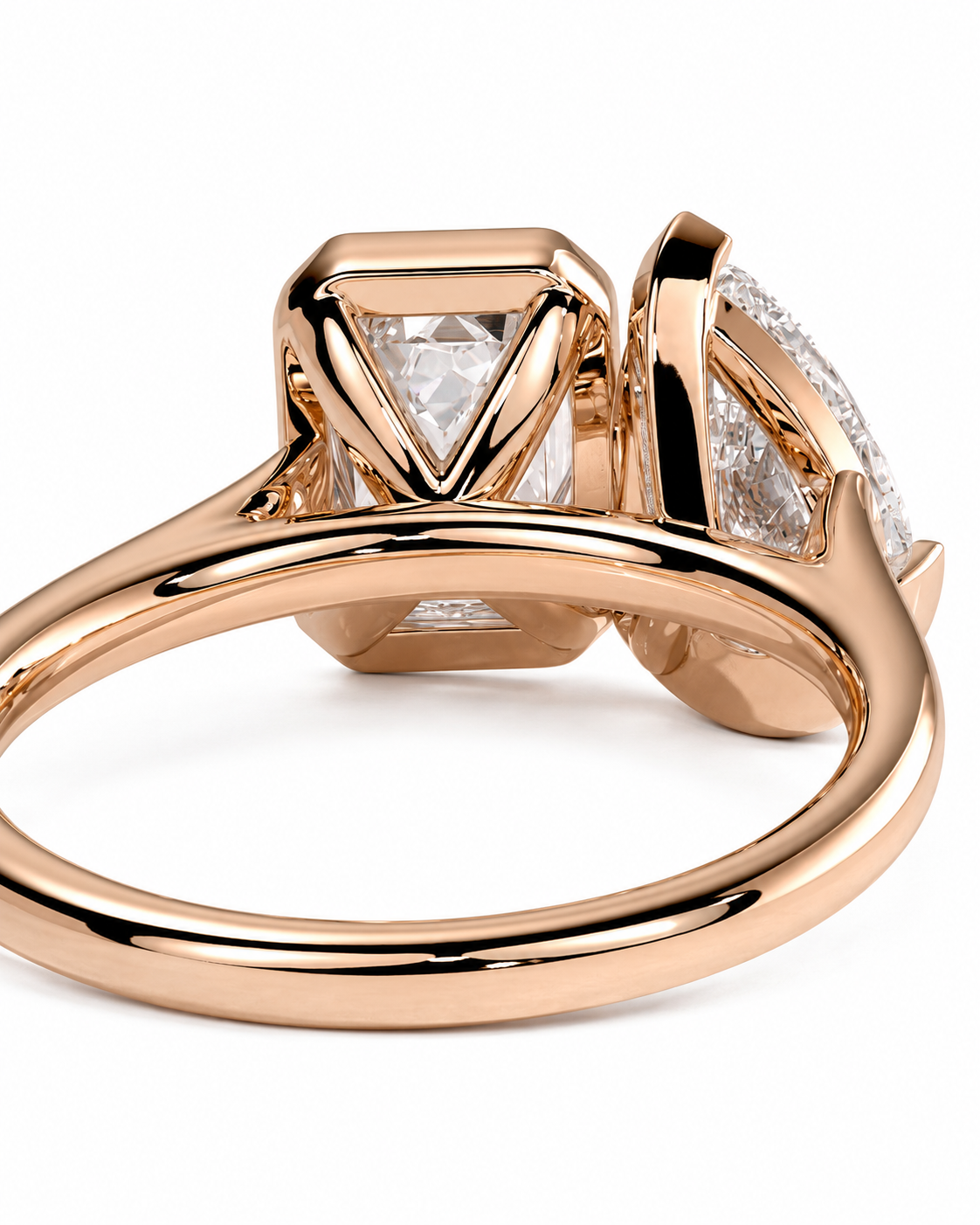 color_10K_RG, color_14K_RG &&Rose gold ring with a triangular-cut clear center stone and a larger round clear side stone, photographed on a clean white background.