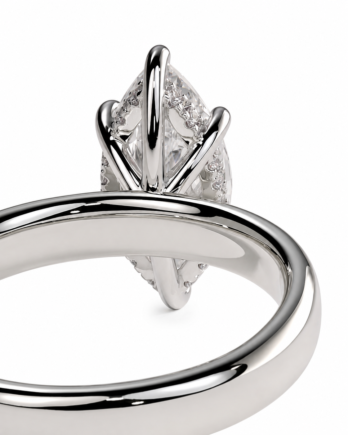 color_925_SIL,color_935_ARG,color_10K_WG, color_14K_WG &&A close-up studio shot of a silver-toned ring with a marquise-cut clear gemstone in a prong setting, shown against a plain white background.
