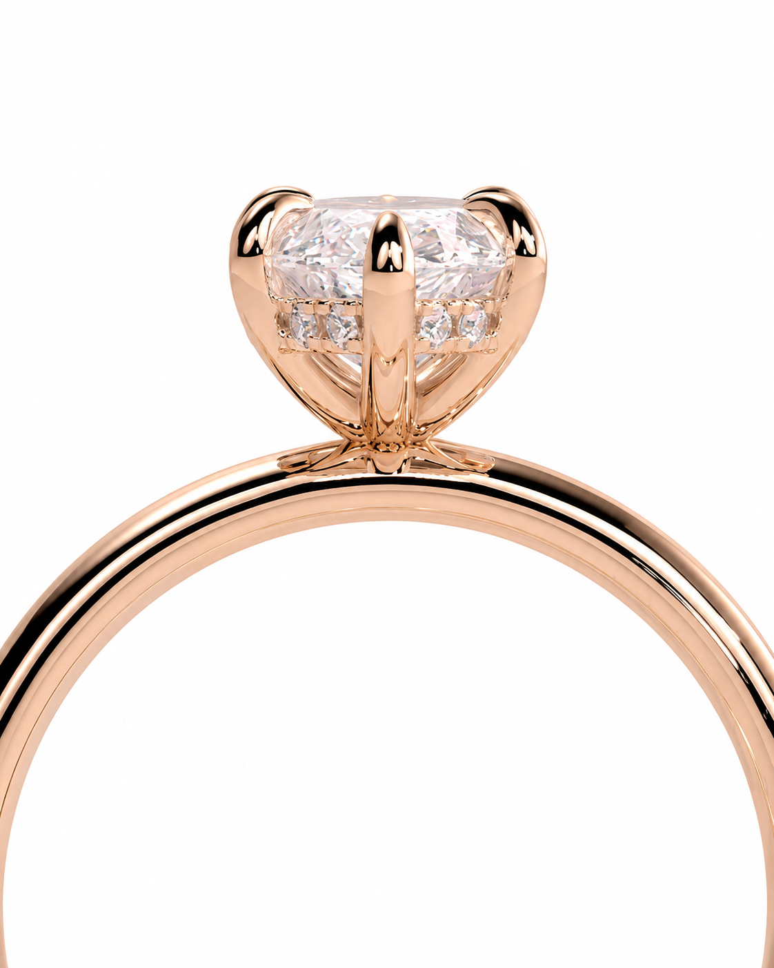 color_10K_RG, color_14K_RG &&A close-up of a rose gold solitaire engagement ring featuring a round brilliant-cut diamond in a four-prong setting, shown against a solid white background.