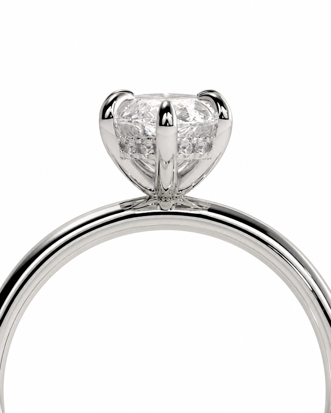 color_925_SIL,color_935_ARG,color_10K_WG, color_14K_WG &&A close-up shot of a classic solitaire engagement ring featuring a round brilliant-cut diamond set in a polished four-prong silver-colored metal band, shown against a solid white background.