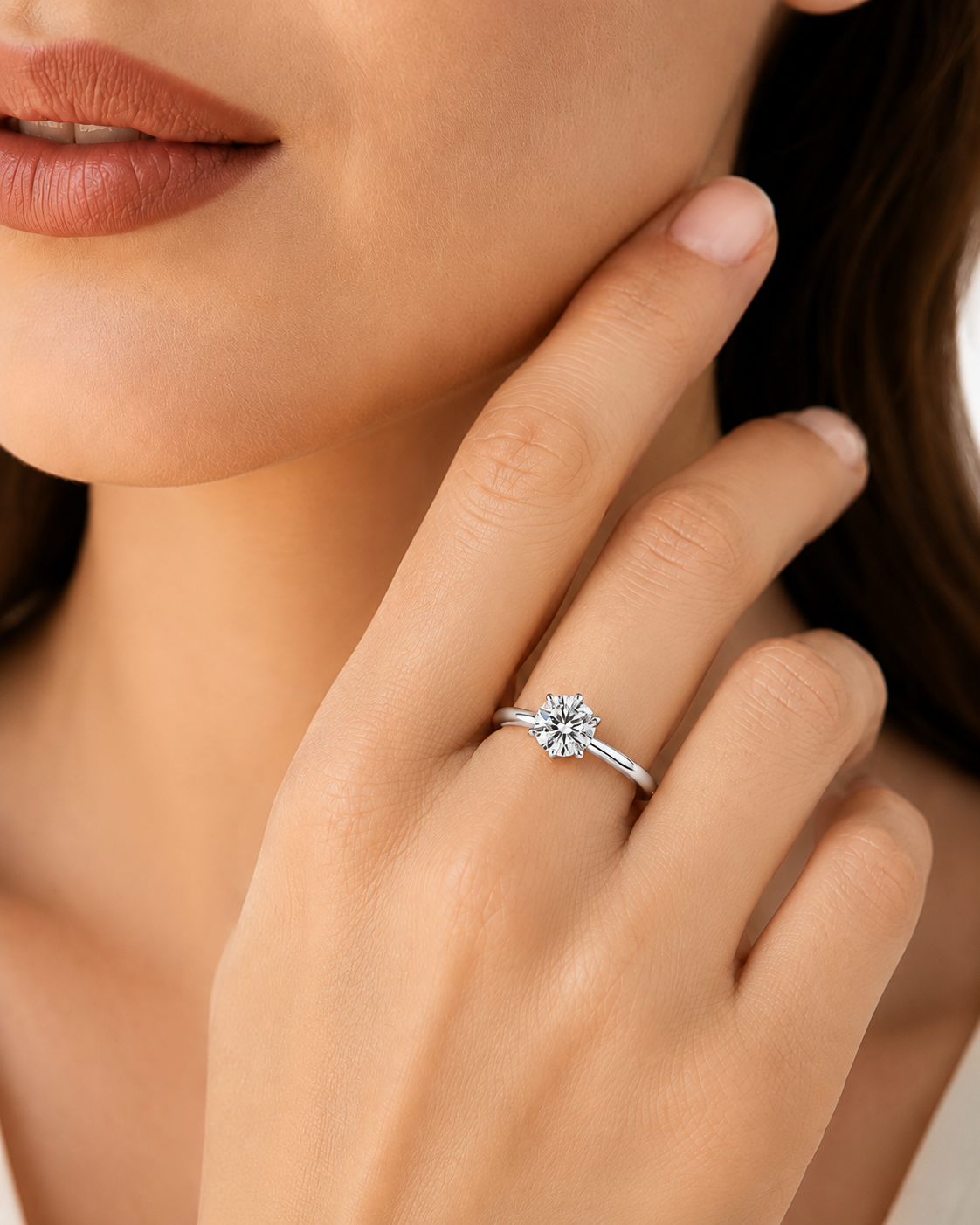 color_925_SIL,color_935_ARG,color_10K_WG, color_14K_WG &&A close-up lifestyle shot of a woman's hand wearing a silver-toned diamond ring with a flower-like cluster setting on her ring finger.