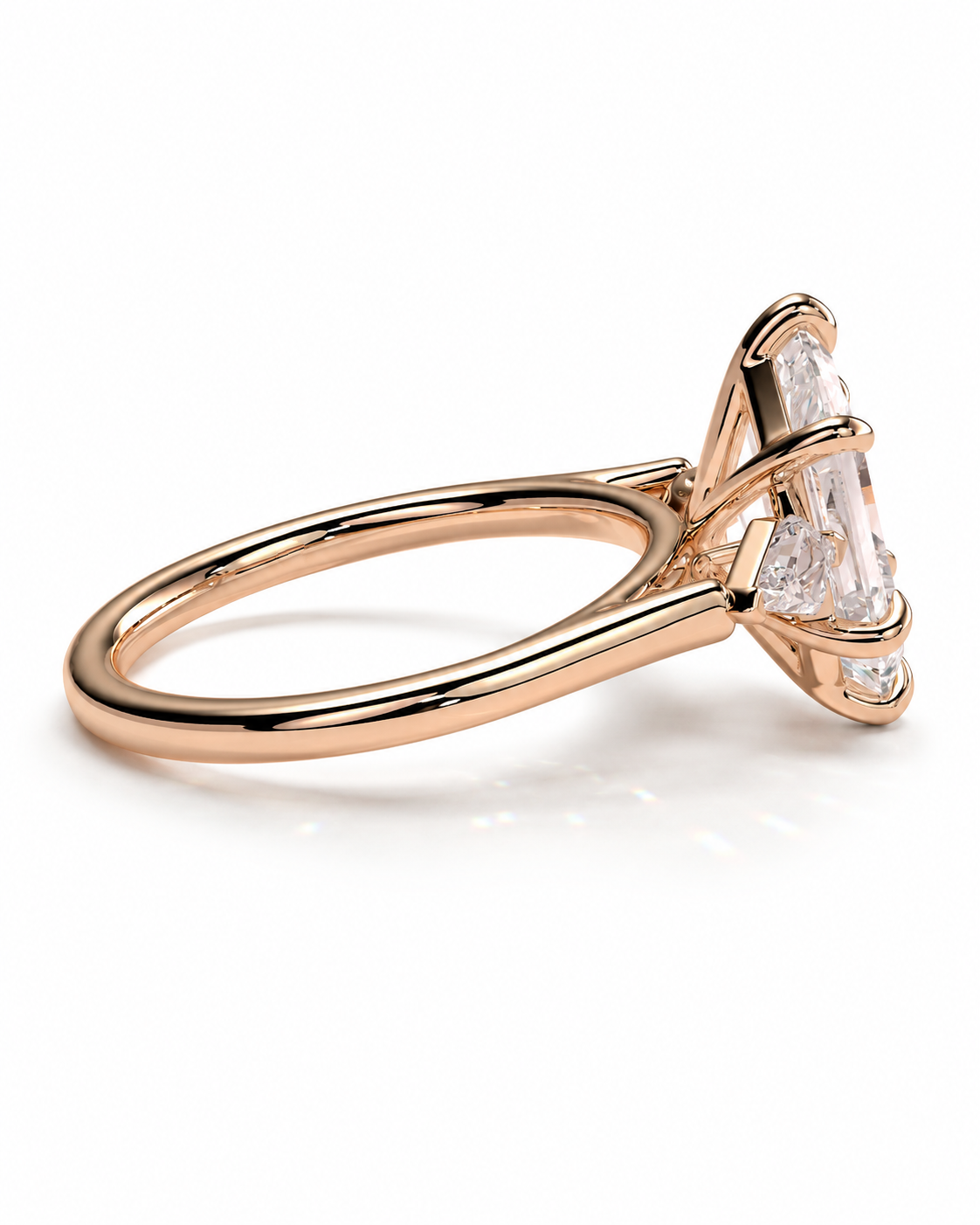 color_10K_RG, color_14K_RG &&A rose gold diamond ring with a large baguette-cut center stone and smaller side stones, shown in a three-quarter side view on a white background.