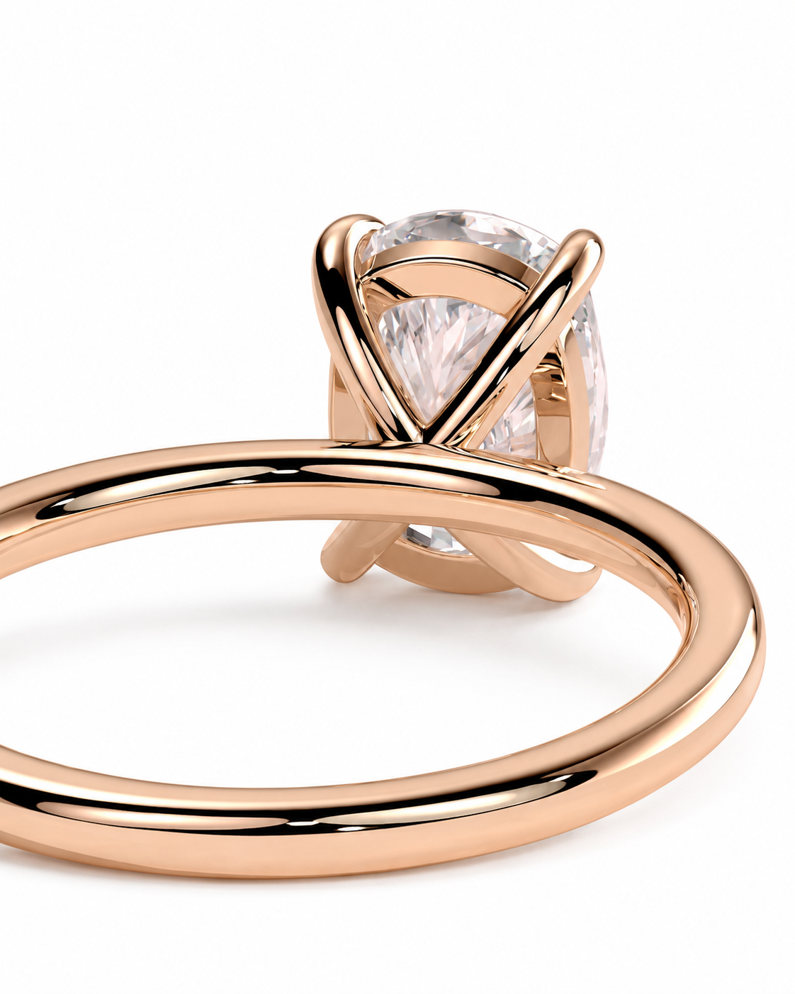 color_10K_RG, color_14K_RG &&A close-up of a rose gold ring with a pear-cut clear gemstone in a wrap-style setting, shown on a clean white background.
