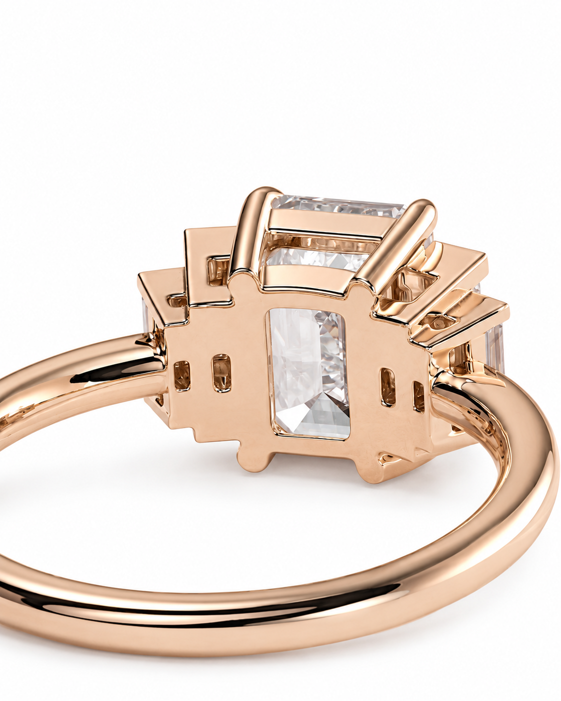color_10K_RG, color_14K_RG &&Rose gold ring with a geometric cluster setting featuring a large rectangular clear gemstone and smaller accent stones, shown on a white background.