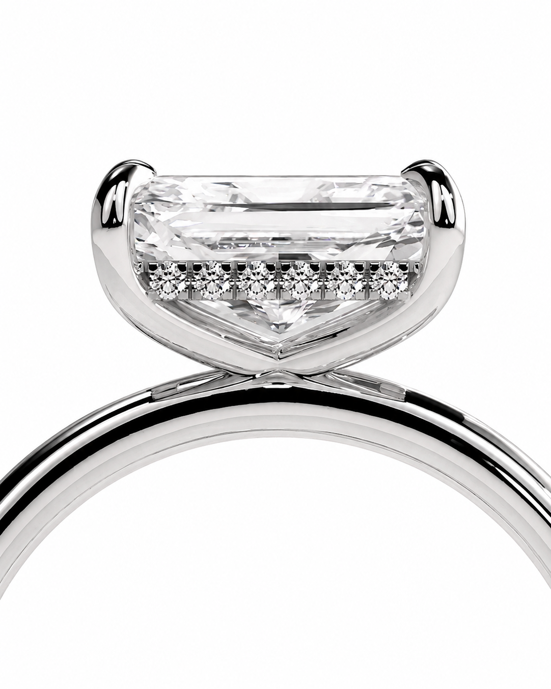 color_925_SIL,color_935_ARG,color_10K_WG, color_14K_WG &&Close-up of a silver-toned ring with a large rectangular clear gemstone and a row of small pavé-set stones along the band, shown on a white background.