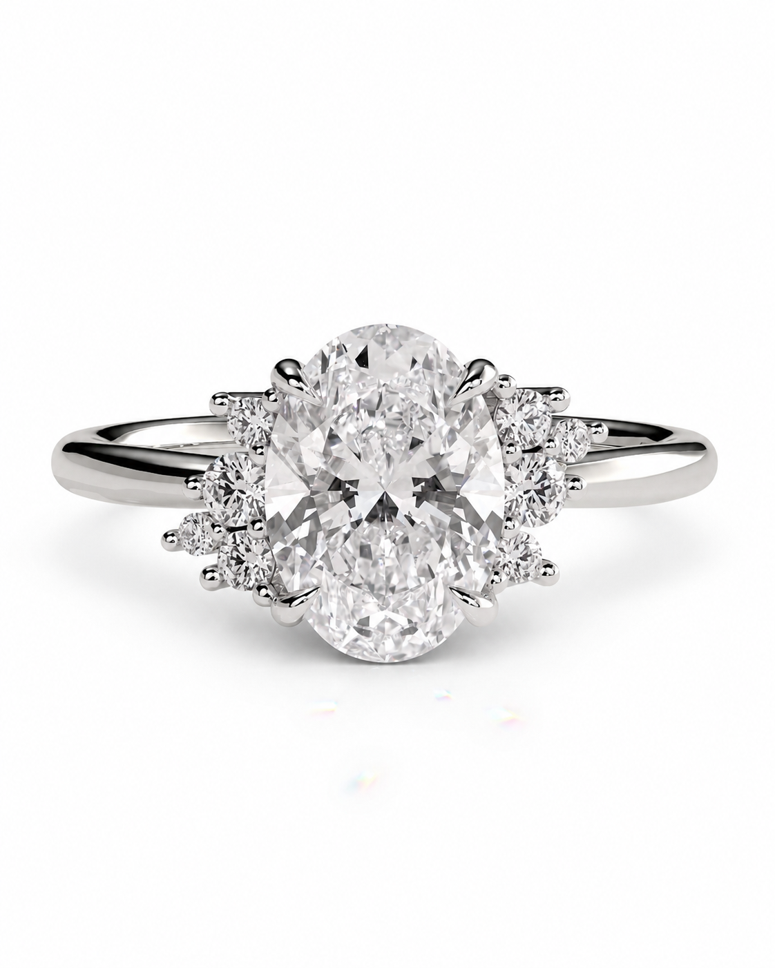 color_925_SIL,color_935_ARG,color_10K_WG, color_14K_WG &&An oval diamond engagement ring with a brilliant-cut center stone and smaller diamond accents on a polished silver-colored band, set against a plain white background.