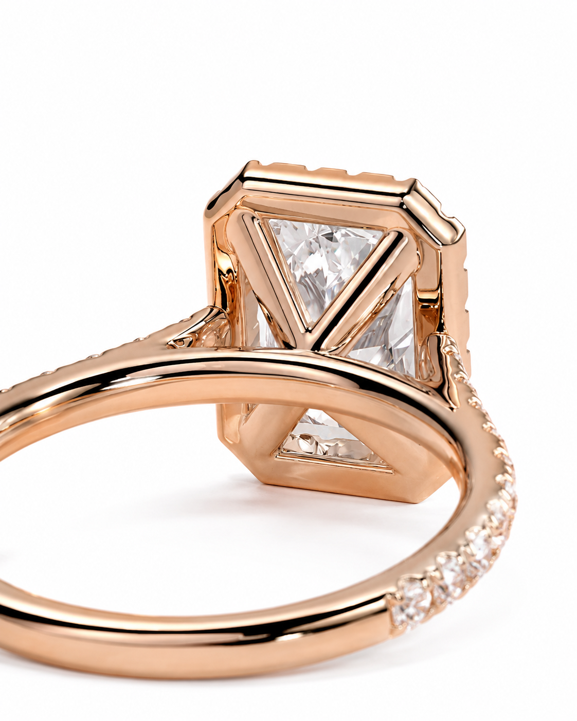 color_10K_RG, color_14K_RG &&A close-up of a rose gold ring featuring a large, geometric bezel-set clear gemstone with smaller accent stones along the band, set against a clean white background.
