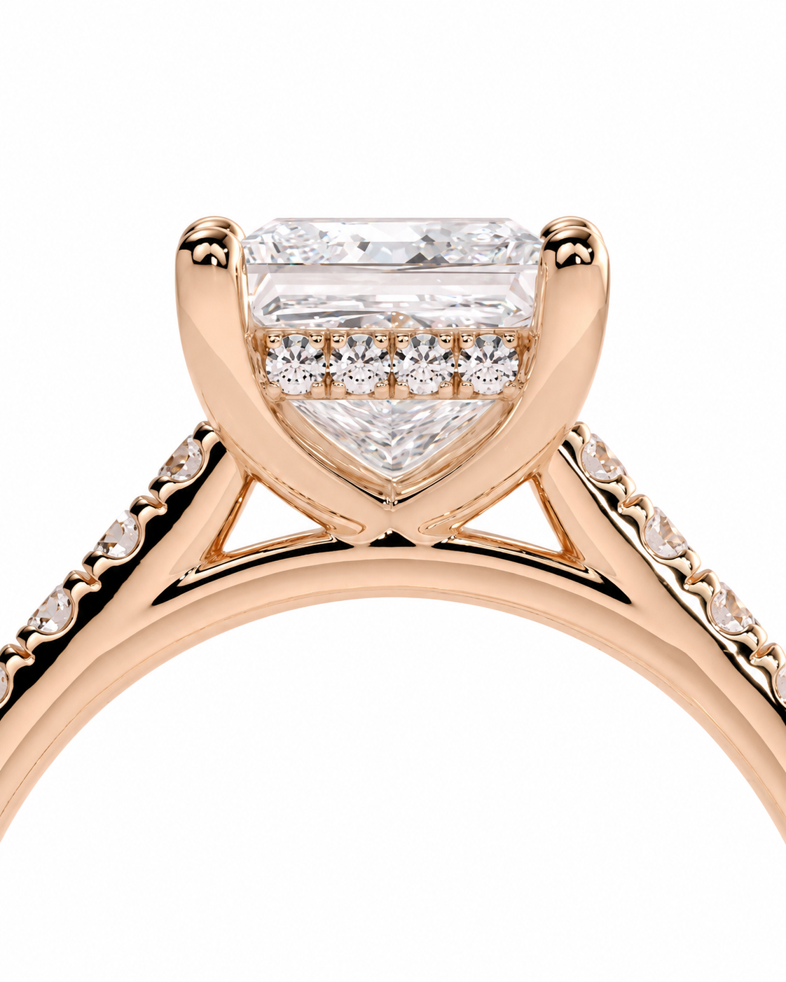 color_10K_RG, color_14K_RG &&A close-up of a rose gold engagement ring featuring a large emerald-cut diamond center stone with a row of smaller diamonds, set against a plain white background.
