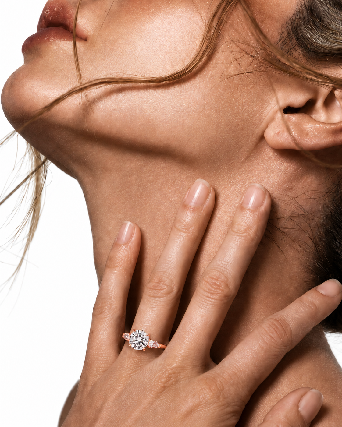 color_10K_RG, color_14K_RG &&A close-up lifestyle shot of a woman's hand resting on her neck, wearing a rose gold ring with a clear round-cut diamond cluster setting against a white background.
