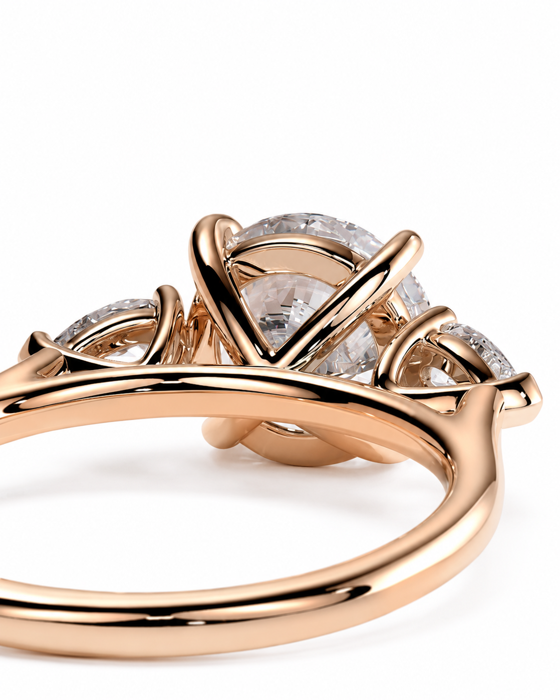 color_10K_RG, color_14K_RG &&Rose gold ring with a three-stone cluster setting featuring clear gemstones, shown in a close-up studio shot on a white background.