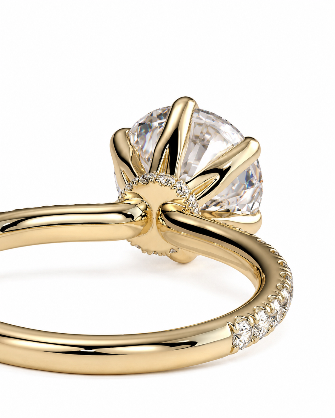 color_10K_YG, color_14K_YG &&A close-up studio shot of a yellow gold ring with a large clear round-cut center stone and small accent stones along the band, set against a plain white background.