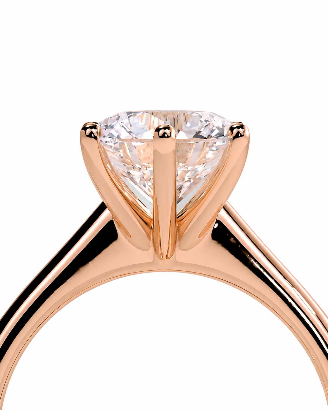 color_10K_RG, color_14K_RG &&A close-up of a rose gold solitaire engagement ring featuring a heart-shaped clear gemstone in a prong setting, shown against a solid white background.