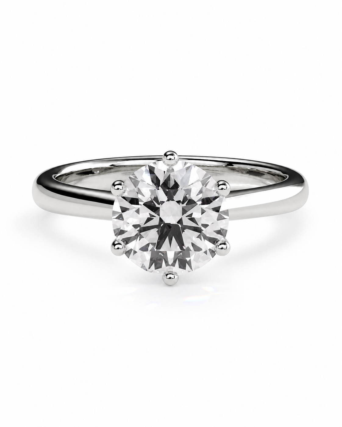 color_925_SIL,color_935_ARG,color_10K_WG, color_14K_WG &&A classic round solitaire engagement ring featuring a brilliant-cut clear center stone in a six-prong setting on a polished silver-colored band, shown against a seamless white background.
