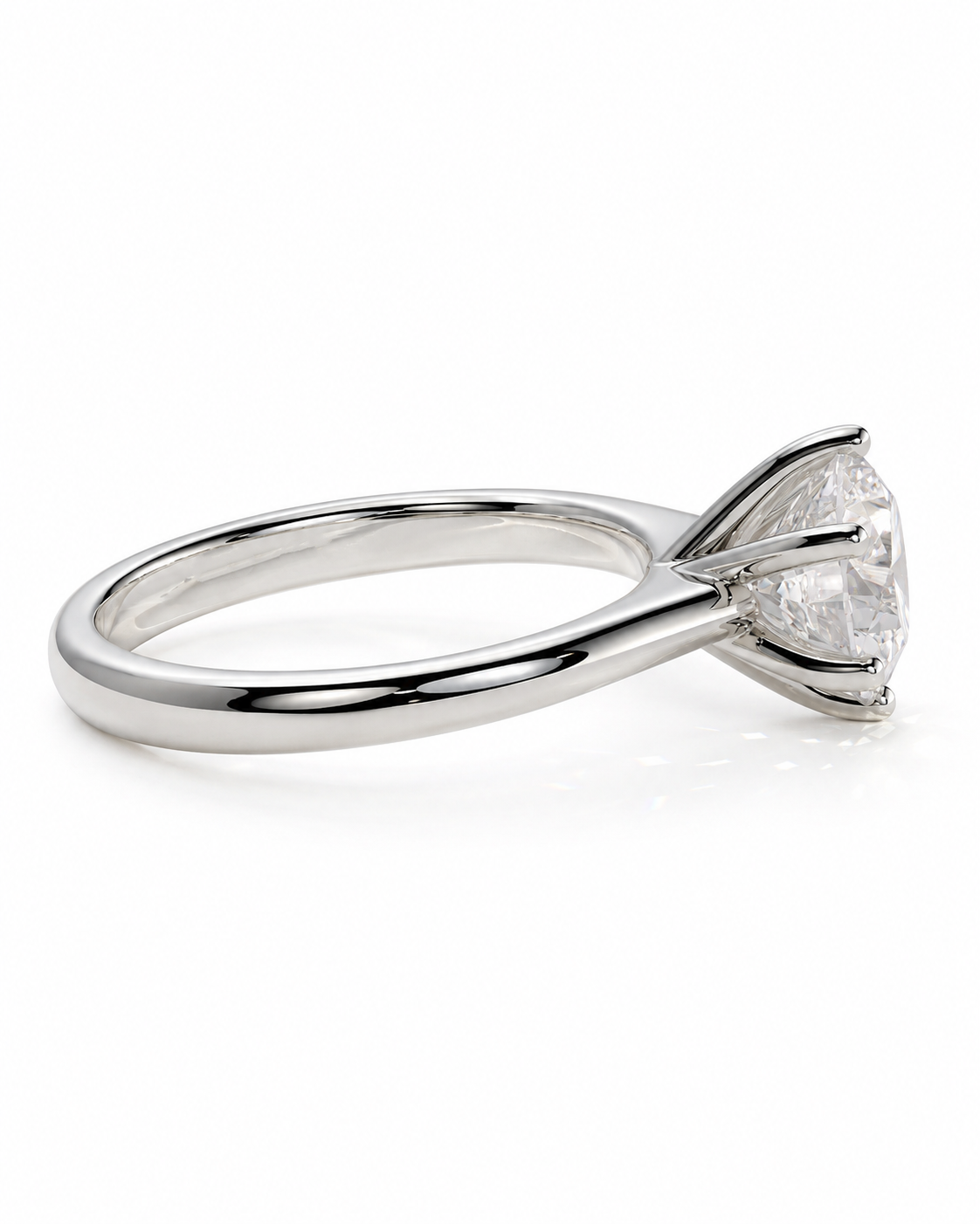 color_925_SIL,color_935_ARG,color_10K_WG, color_14K_WG &&A silver-toned solitaire engagement ring with a round brilliant-cut diamond, shown in a side profile on a clean white background.
