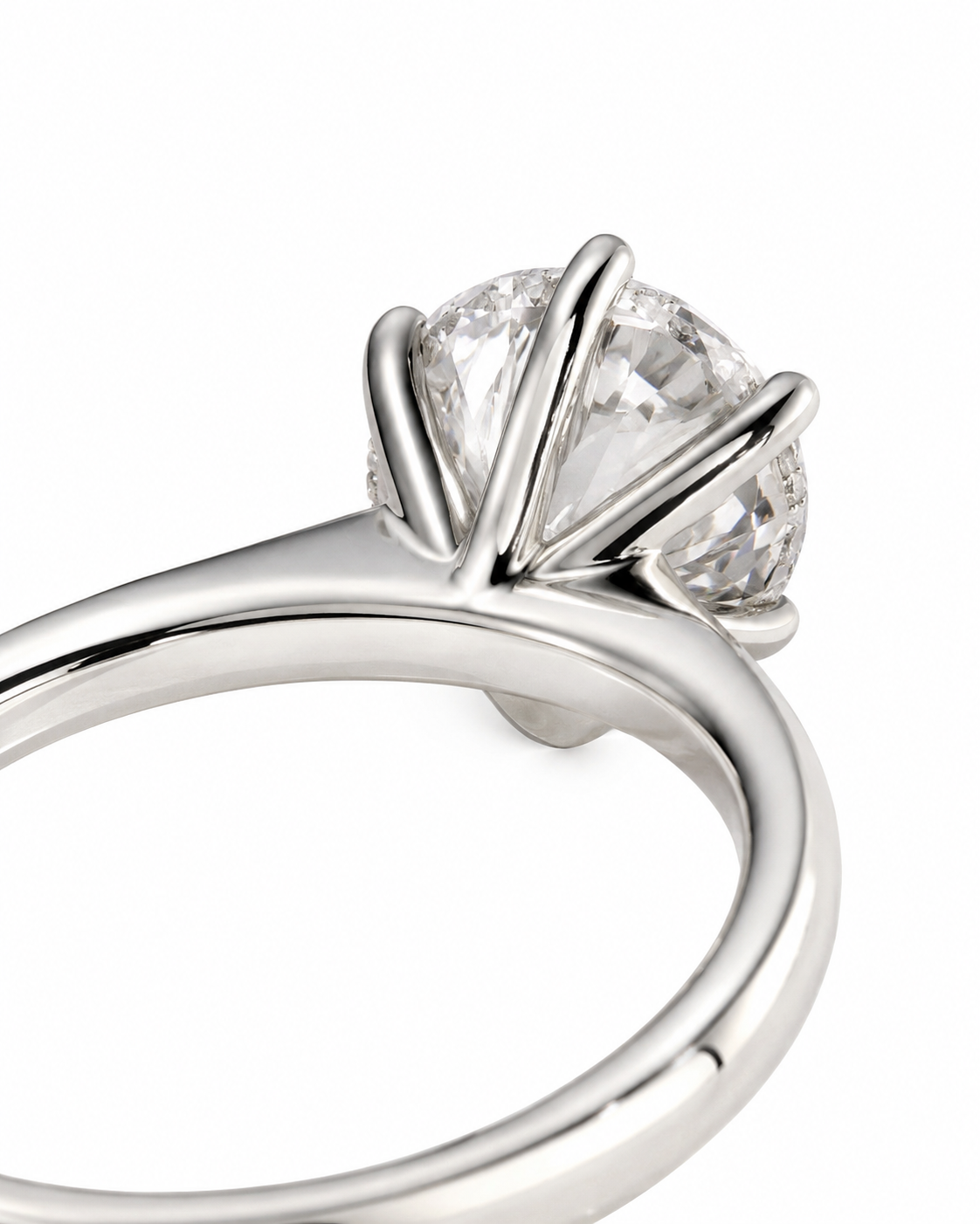 color_925_SIL,color_935_ARG,color_10K_WG, color_14K_WG &&A close-up shot of a silver-toned solitaire engagement ring with a round brilliant-cut diamond in a prong setting, shown on a plain white background.
