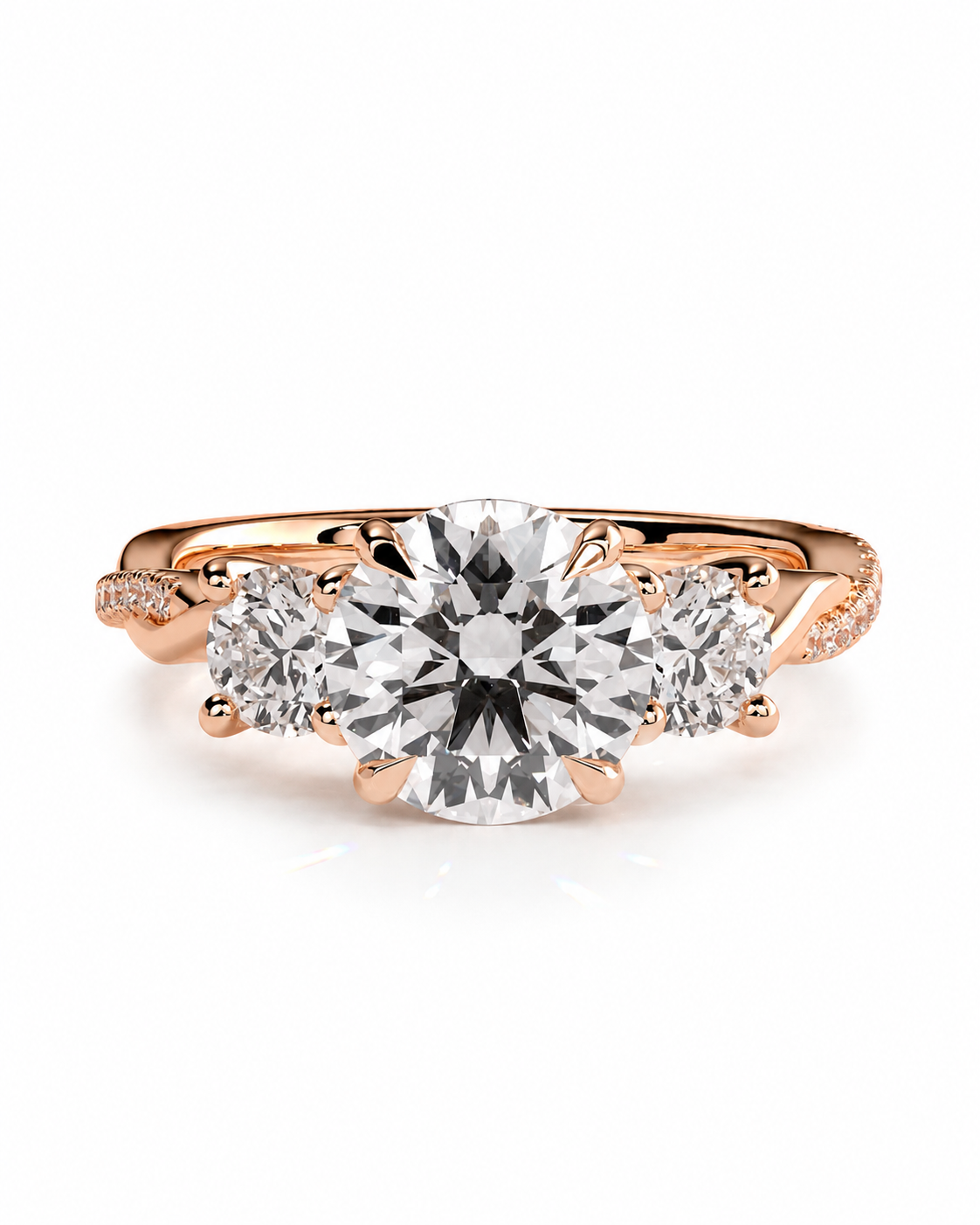 color_10K_RG, color_14K_RG &&A rose gold three-stone engagement ring featuring a large round center diamond flanked by two smaller round diamonds, set against a clean white background.