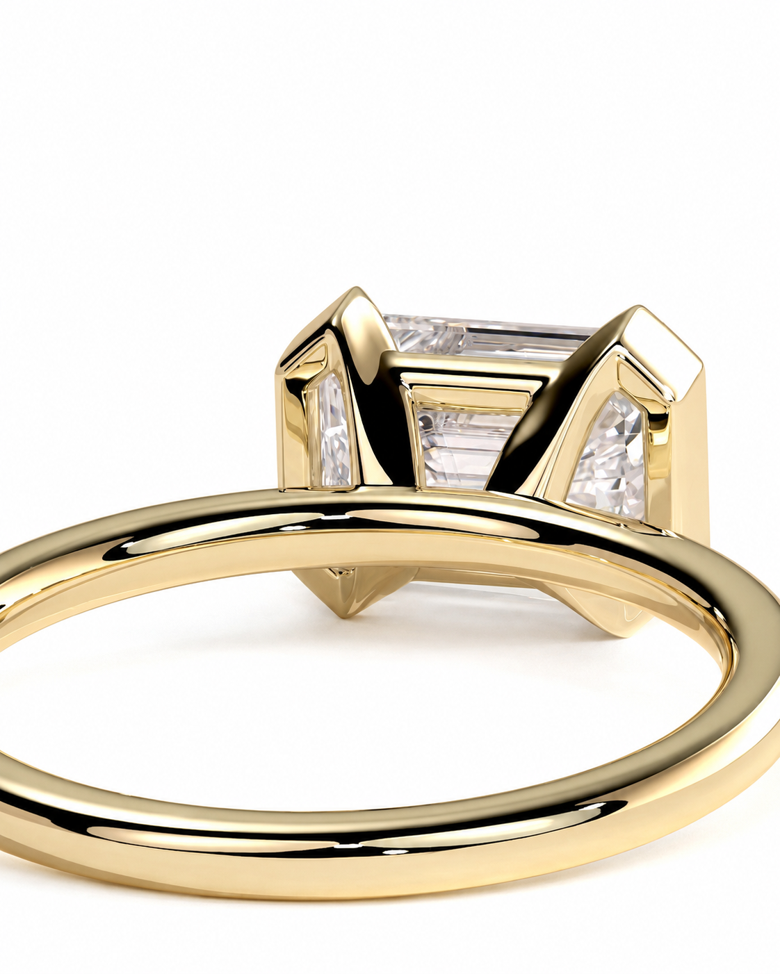 color_10K_YG, color_14K_YG &&A close-up shot of a yellow gold ring with a square baguette-cut clear center stone and smaller side stones, set against a plain white background.