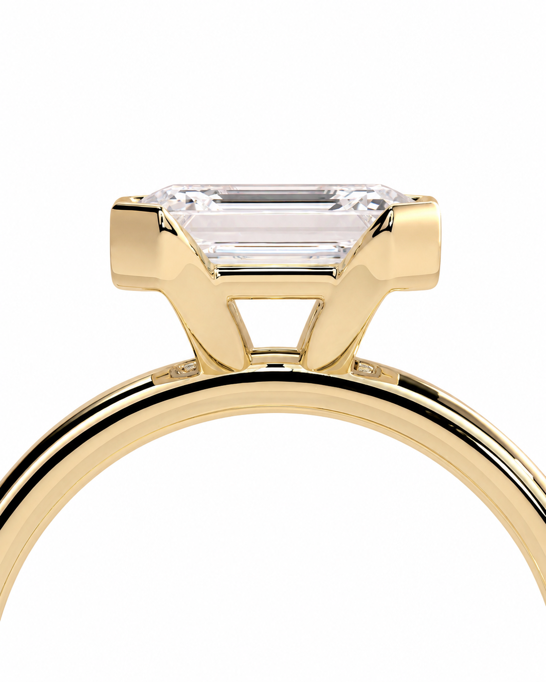 color_10K_YG, color_14K_YG &&A close-up of a yellow gold ring featuring an emerald-cut clear gemstone in a prong setting, shown against a plain white background.