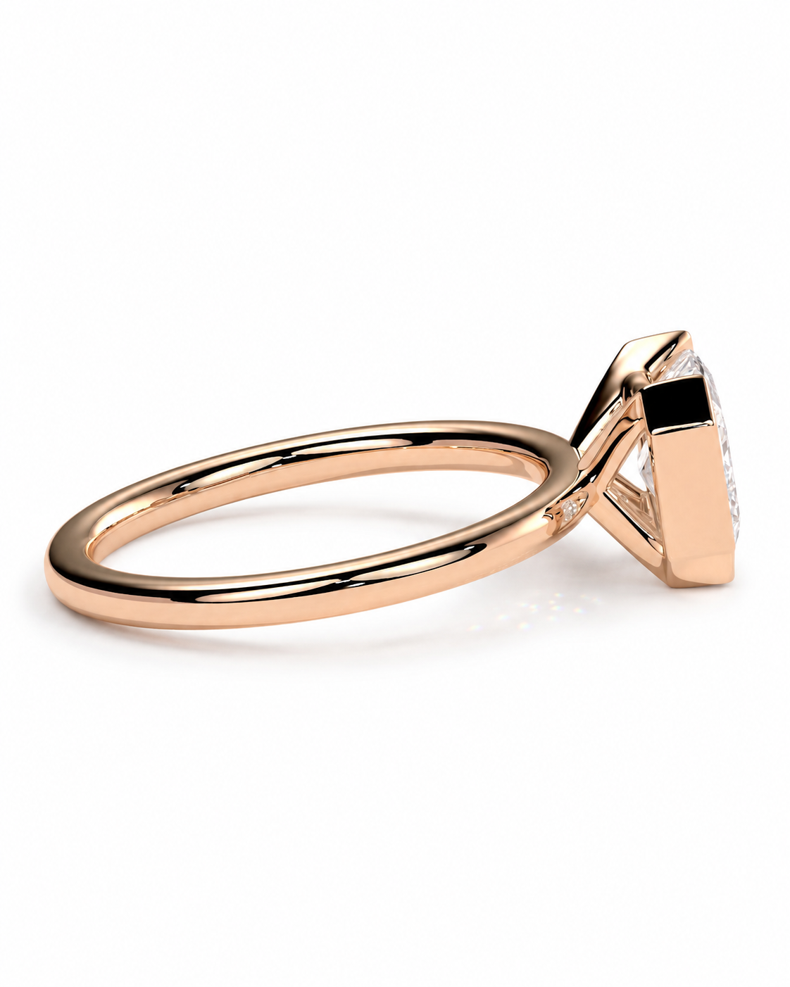 color_10K_RG, color_14K_RG &&A close-up side view of a rose gold ring with a triangular bezel setting and a clear gemstone, shown on a clean white background.